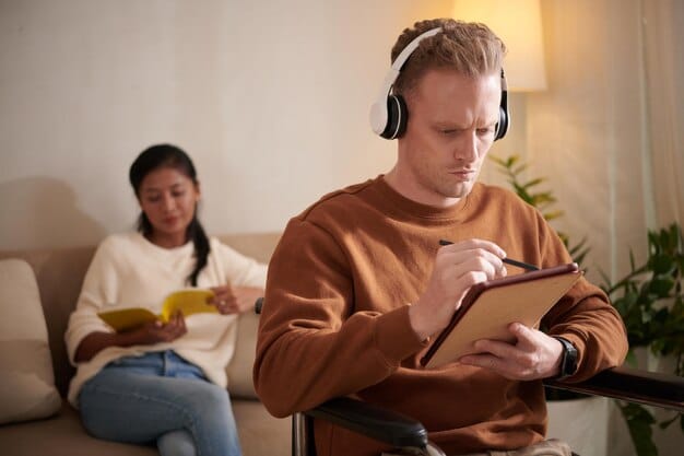 A person listening to a lecture with headphones on, taking notes on a tablet with a stylus, representing the use of technology to enhance auditory learning.