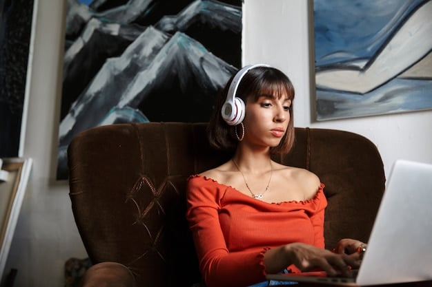 A person wearing headphones, listening to a podcast on a laptop while sitting in a coffee shop. The laptop screen shows a podcast interface with play/pause buttons and episode information. The ambiance is relaxed, with soft background lighting and a few other patrons in the vicinity, suggesting an environment conducive to focused listening and learning.