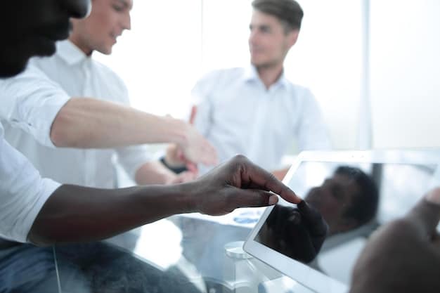 Employees participating in a hands-on simulation during a training session, with an instructor guiding them.