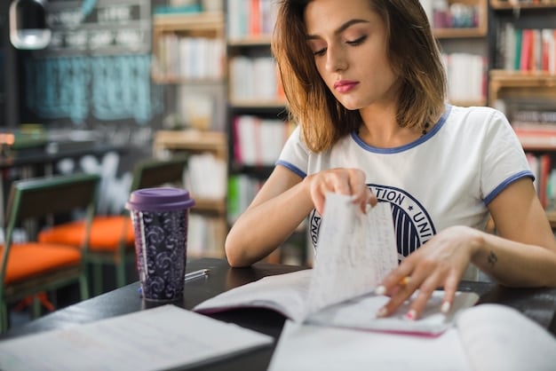 A student working on a practice exam paper in a library. They are focused and using a timer to keep track of their progress.