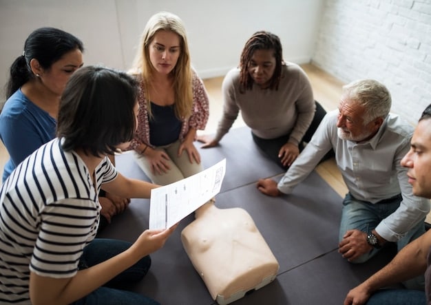 A group of employees participating in a memory training workshop. They are actively engaged in various exercises, such as using flashcards, solving puzzles, and discussing memory techniques. The atmosphere is collaborative and encouraging, with a trainer guiding the session.