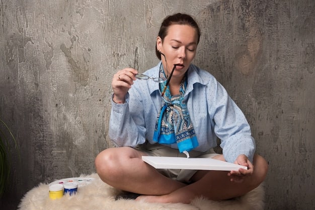 A person sitting cross-legged on the floor, surrounded by notebooks and pens, deeply engrossed in a reflective journaling session about their learning experiences, with a thoughtful expression.
