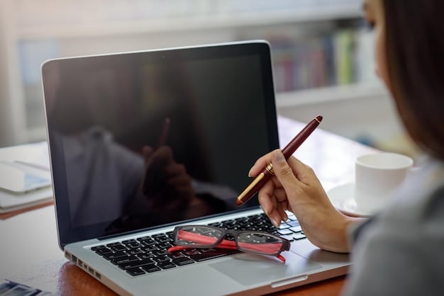 A person efficiently managing their study materials, with a laptop showing a video, physical notes open, and a pen in hand, depicting integrated learning in a time-efficient manner.