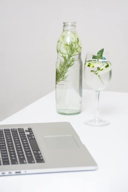 A minimalist and clean study desk with a laptop, a few books, and a glass of water, emphasizing a distraction-free environment.